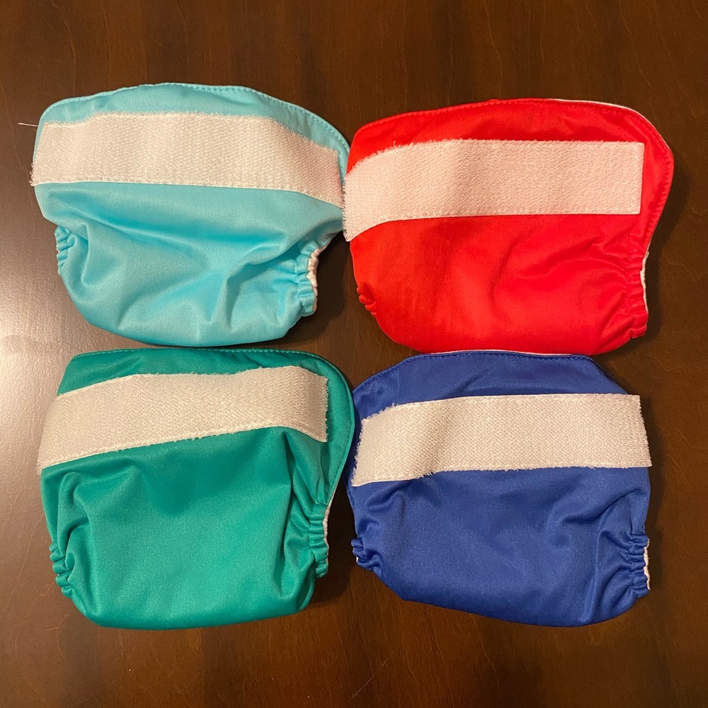 Four BumGenius Newborn AIO Diapers